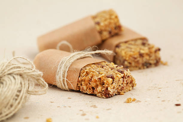 Granola bar or flapjacks on baking paper with hemp string Granola bar or flapjacks, cute on baking paper with hemp string chewy stock pictures, royalty-free photos & images