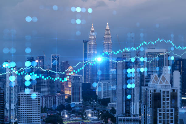 FOREX graph hologram, aerial night panoramic cityscape of Kuala Lumpur. KL is the developed location for stock market researchers in Malaysia, Asia. The concept of fundamental analysis. FOREX graph hologram, aerial night panoramic cityscape of Kuala Lumpur. KL is the developed location for stock market researchers in Malaysia, Asia. The concept of fundamental analysis. central market kuala lumpur stock pictures, royalty-free photos & images