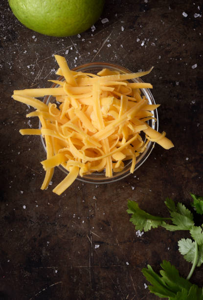 Grated cheddar cheese Grated orange cheddar cheese view from above cheddar cheese stock pictures, royalty-free photos & images