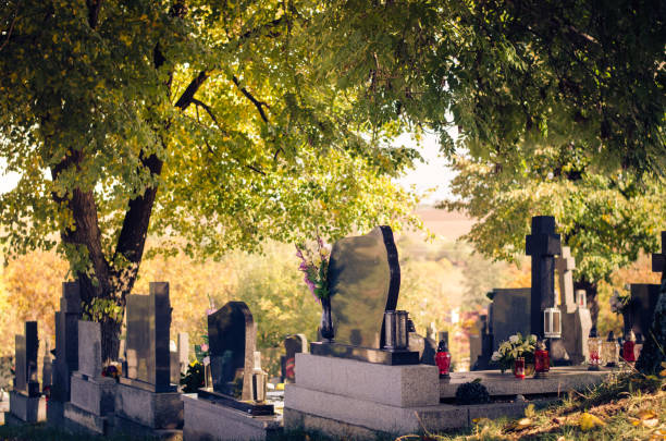 graves in the cemetery in the autumn season stock photo