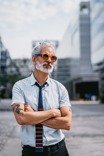 Portrait of gray hair businessman with tattoo. Buenos Aires, Argentina.