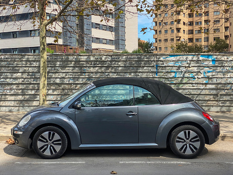 Valencia, Spain - September 21, 2020: Gray Volkswagen car model New Beetle parked in the street. This car is the modern updated version of the famous old VW Beetle of the 20th century