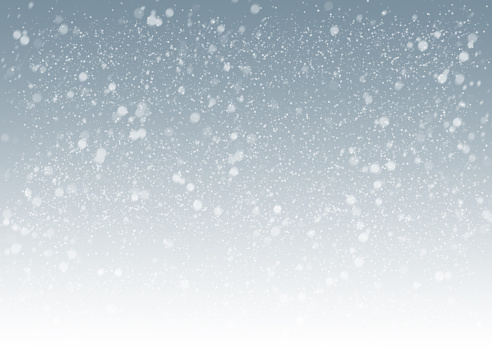 horizontal shot of gray winter background with snowflakes flying all over it.winter is coming.