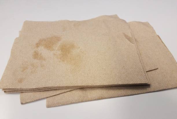 grease on a pile of brown napkins stock photo
