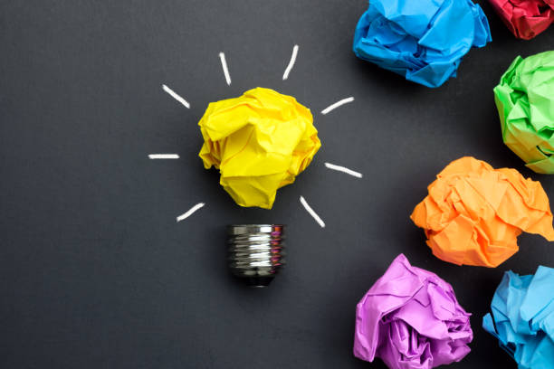 Great idea concept with crumpled colorful paper and light bulb stock photo