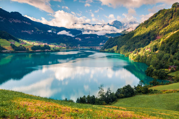 Great summer view of Lungerersee lake. Colorful morning scene of Swiss Alps, Lungern village location, Switzerland, Europe. Beauty of nature concept background. Great summer view of Lungerersee lake. Colorful morning scene of Swiss Alps, Lungern village location, Switzerland, Europe. Beauty of nature concept background. lungern village switzerland lake stock pictures, royalty-free photos & images