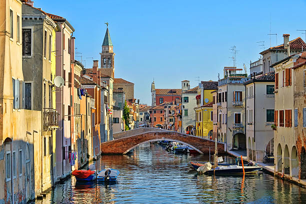 Great water view of Chioggia with vintage cabins and bridge stock photo