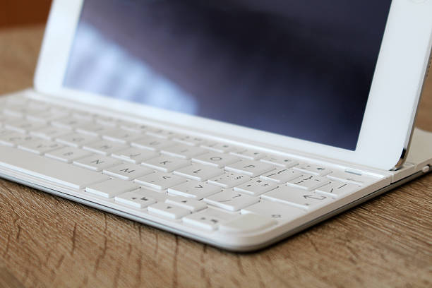Great white tablet with modern keyboard at office stock photo