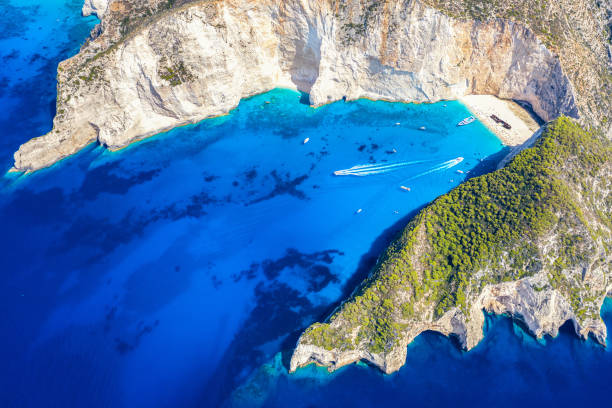 greece iconic vacation picture. aerial drone view of the famous shipwreck navagio beach on zakynthos island, greece - navagio beach stockfoto's en -beelden