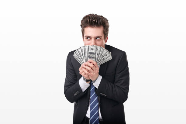 Greedy businessman with dollar banknotes making evil plans stock photo
