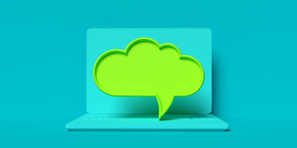 Green 3D speech bubble on blue laptop. Pc and portable information device applications stock photo