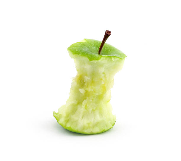 Green apple core Green apple core against a white background leftovers stock pictures, royalty-free photos & images