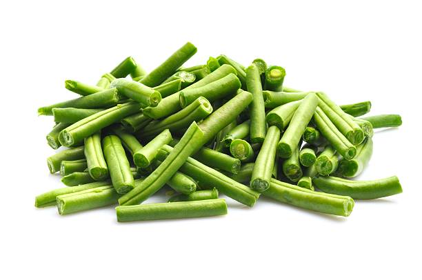 Green beans Pile of prepared Green Beans ready for cooking isolated on a white background. green bean stock pictures, royalty-free photos & images