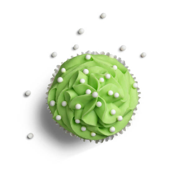 Green Cupcake Cupcake with green icing against white background. turkey cupcake cake stock pictures, royalty-free photos & images