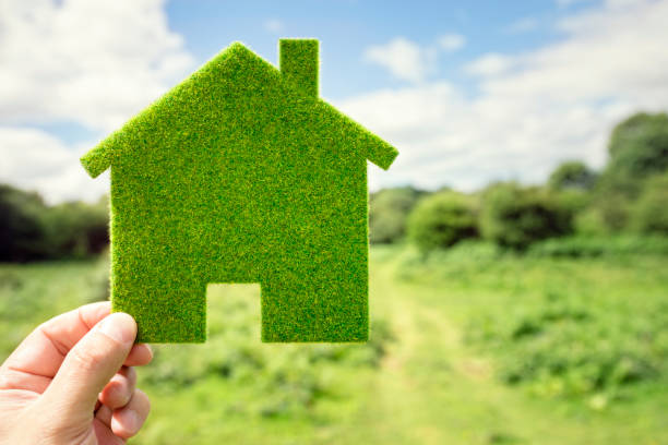 Green eco house environmental background Green eco house environmental background in field for future residential building plot energy efficient stock pictures, royalty-free photos & images