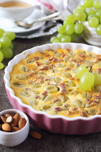 Green grape clafoutis with  almonds  and cup of tea stock photo