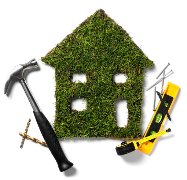 Green Grass House and Tools Eco house cut out of grass with construction tools isolated on white. green building stock pictures, royalty-free photos & images