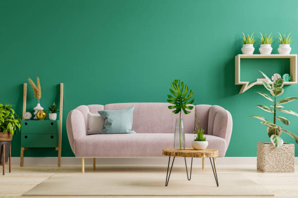 Green interior in modern interior of living room style with pink sofa and green wall.