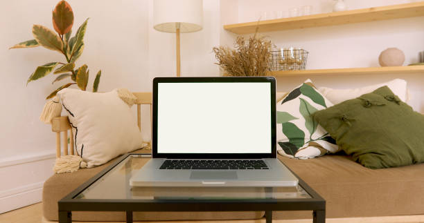 Green laptop screen in a cozy interior stock photo