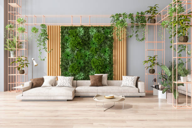 Green Living Room With Vertical Garden, House Plants, Beige Color Sofa And Parquet Floor stock photo