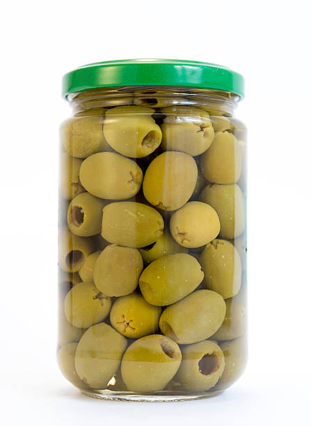 Green olives jar Green olives in a jar isolated on white. green olives jar stock pictures, royalty-free photos & images