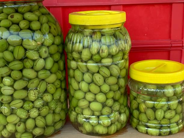 green olives hand made pickled scratched green olives green olives jar stock pictures, royalty-free photos & images