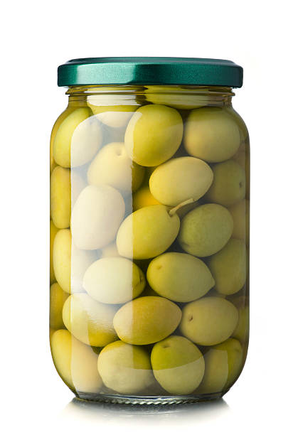 Green olives Green olives jar on a white background green olives jar stock pictures, royalty-free photos & images