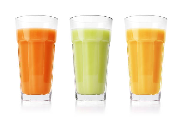 Green, orange and yellow smoothies Green, orange and yellow smoothies in glasses isolated on white background mango smoothie stock pictures, royalty-free photos & images