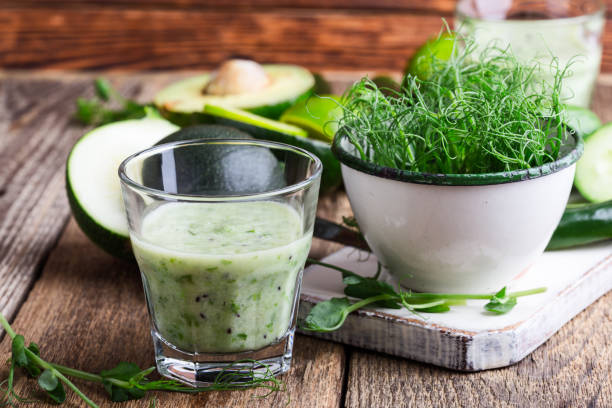 Green pear sprouts, fresh vegetables and smoothie Green pear sprouts, fresh vegetables and smoothie for healthy and delicious  full of vitamins meal.   Dairy smoothie with micro greens  and vegetables ready to eat microgreen smoothie stock pictures, royalty-free photos & images