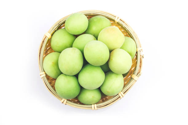 Green plum isolated on white background stock photo