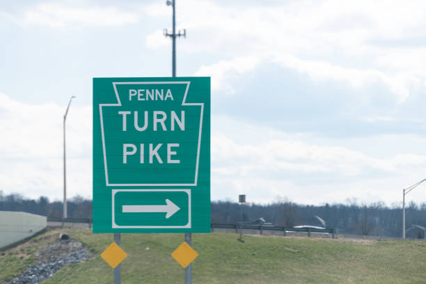 Green road sign to Penna Pennsylvania Turnpike highway toll freeway stock photo