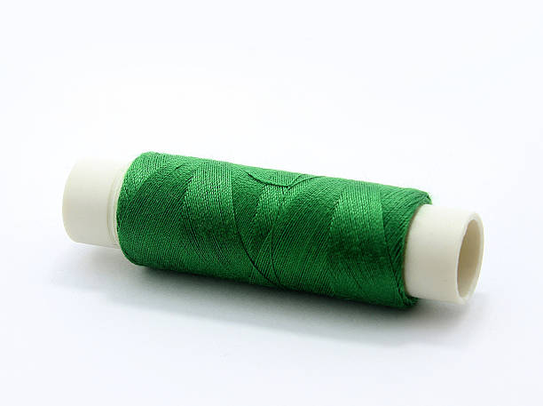 Green sewing thread stock photo