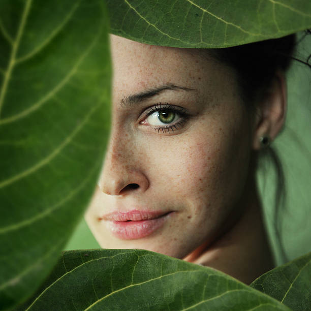 green sight a close-up portrait of young beautiful women in leaf frame healthy skin stock pictures, royalty-free photos & images