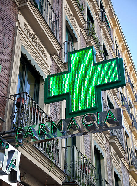 Green sign of the pharmacy in Madrid stock photo