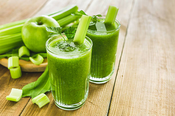 Green smoothie with celery, spinach and apple Green smoothie with celery, spinach and apple in two glasses celery stock pictures, royalty-free photos & images