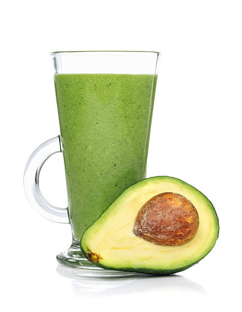 Green smoothies in a glass with avocado stock photo