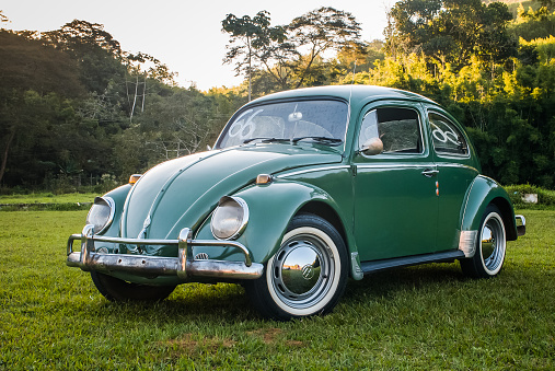 Rio de Janeiro, Brazil - July 27, 2012: A green Beetle is seen stooped at a filed in the rural area of Valencia city, southeast of Brazil. The vehicle is produced by Volkswagen Group, a German multinational automotive manufacturing company headquartered in Wolfsburg, Lower Saxony, Germany.