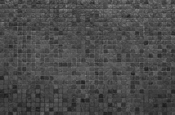 Grey and black mosaic wall texture and background stock photo