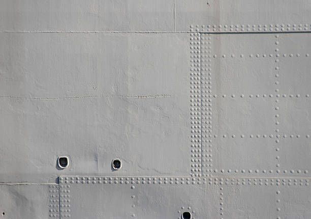 Grey Military Rivets Rivet detail on the hull of an old warship hull stock pictures, royalty-free photos & images