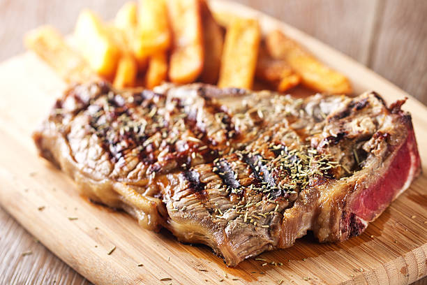Grilled beefsteak with french fries stock photo