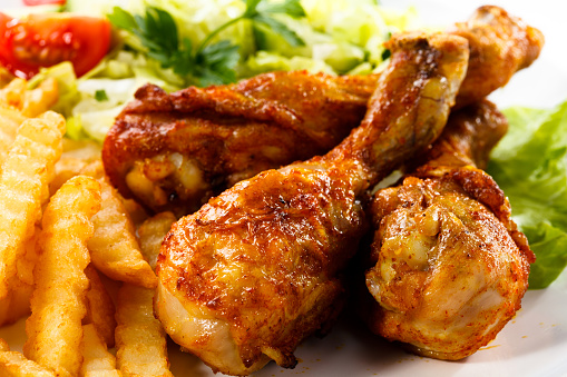Grilled Chicken Legs With Chips And Vegetables Stock Photo - Download ...