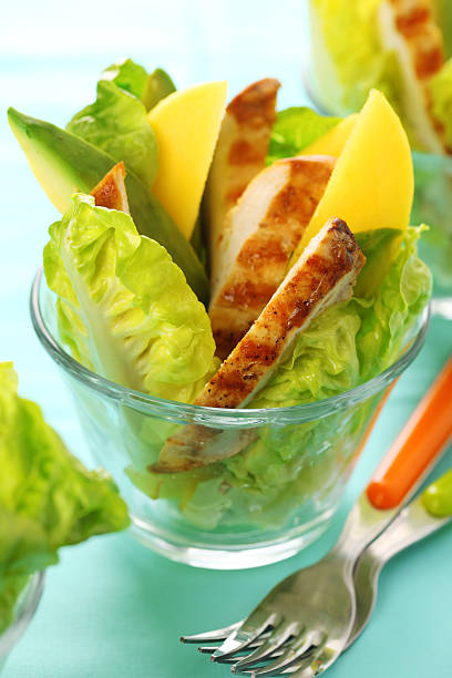 Grilled chicken salad with avocado and mango stock photo