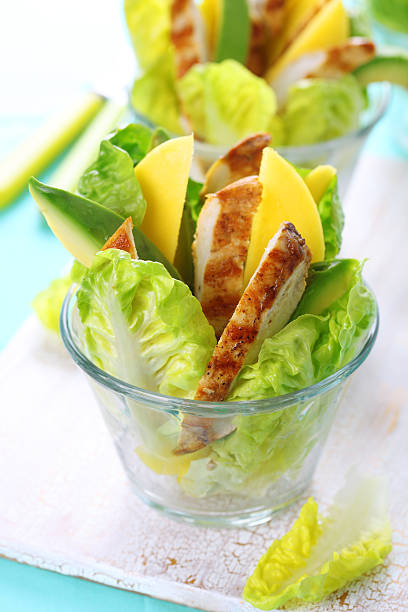 Grilled chicken salad with avocado and mango stock photo