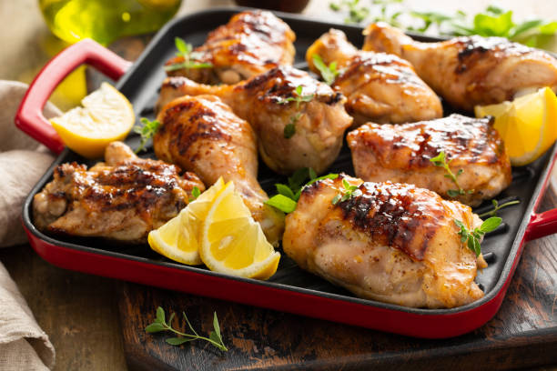 Grilled chicken thighs and drumsticks with honey glaze Grilled chicken thighs and drumsticks with sweet honey glaze chicken thigh meat stock pictures, royalty-free photos & images