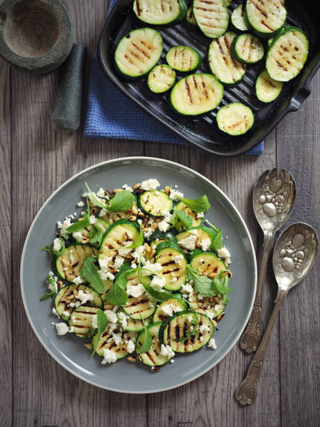 grilled courgette with pine nuts and feta cheese salad stock photo