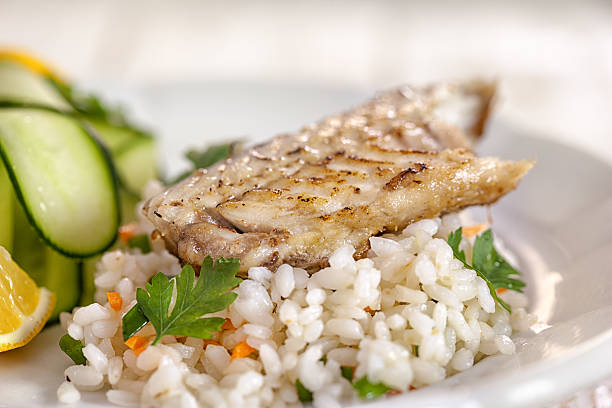 Grilled fish fillet on risotto stock photo