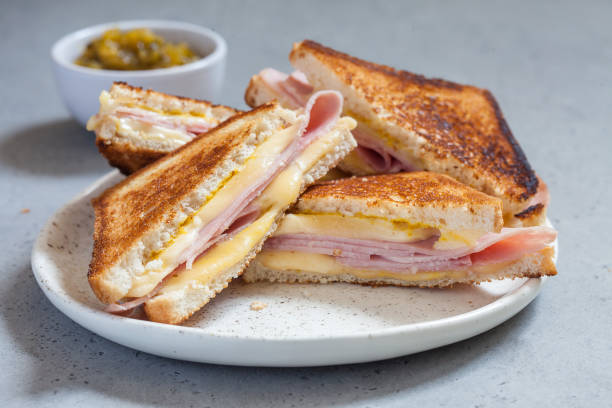 grilled ham and cheese sandwiches grilled ham and cheese sandwiches golden brown toasted food stock pictures, royalty-free photos & images