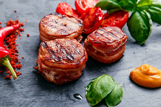 Grilled meat fillet steak wrapped in bacon medallions stock photo