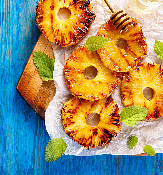 Grilled pineapple slices with addition of honey, top view stock photo