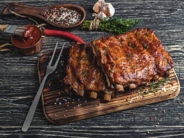 grilled pork ribs with sauce on a cutting board , spice, marinade stock photo